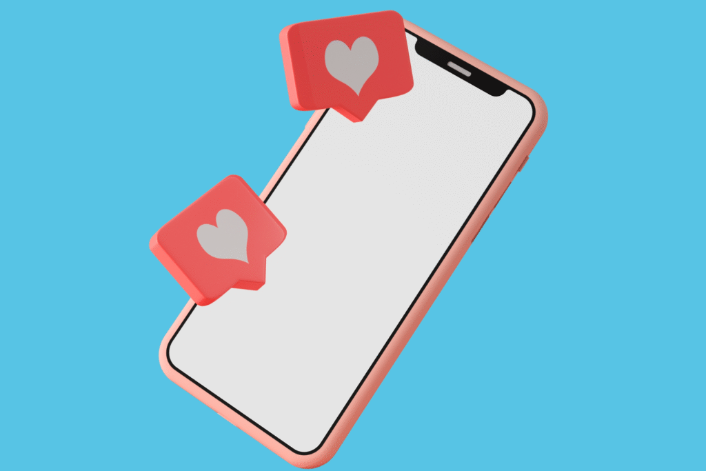A smart phone in a pink case with speech bubbles showing social media likes bursting out of the screen